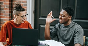 Two men studying and smiling
